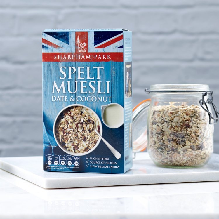 Photo showing the Sharpham Park Date & Coconut Spelt Muesli cereals in a box on a white surface with