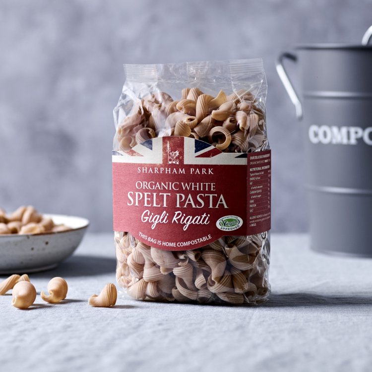 Photo showing the Sharpham Park Organic Spelt White Pasta Gigli Rigati on a white surface with a bow