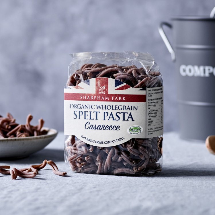 Photo showing the Sharpham Park Organic Spelt Wholegrain Pasta Casarecce on a white surface with a b