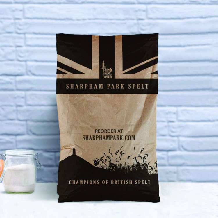 Photo showing the Sharpham Park Organic Rye Flour large bag on a white surface with an open glass ja
