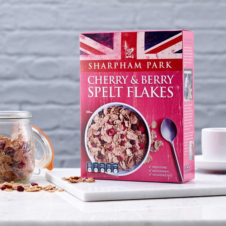 Photo showing the Sharpham Park Cherry & Berry Spelt Multigrain Flakes cereals in a box on a white s