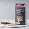 Photo showing the Sharpham Park Organic Pearled Spelt grain box on a white surface with a white bowl